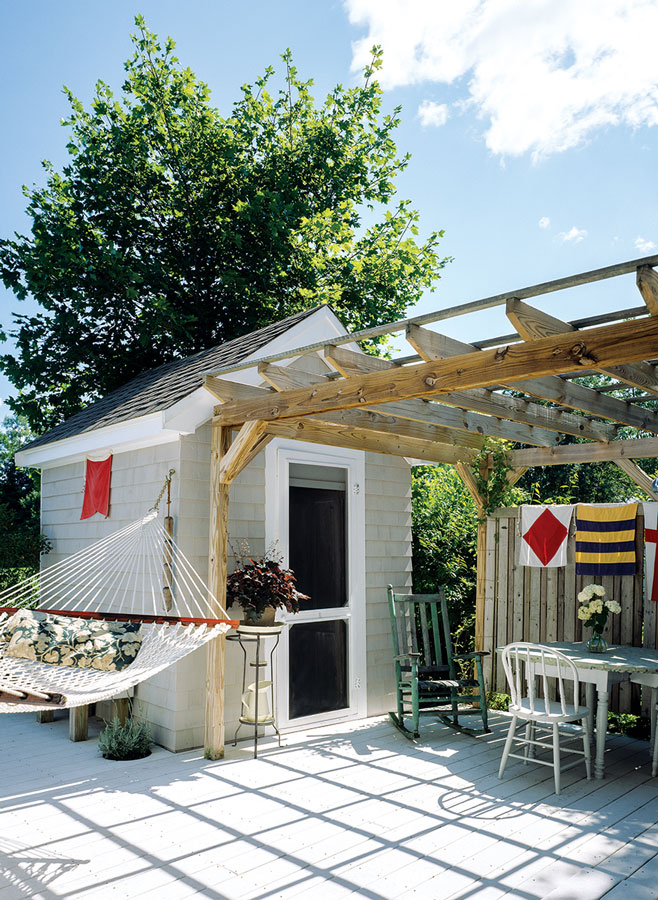 deck that links the mansard tiny home to a shed and bunkhouse.